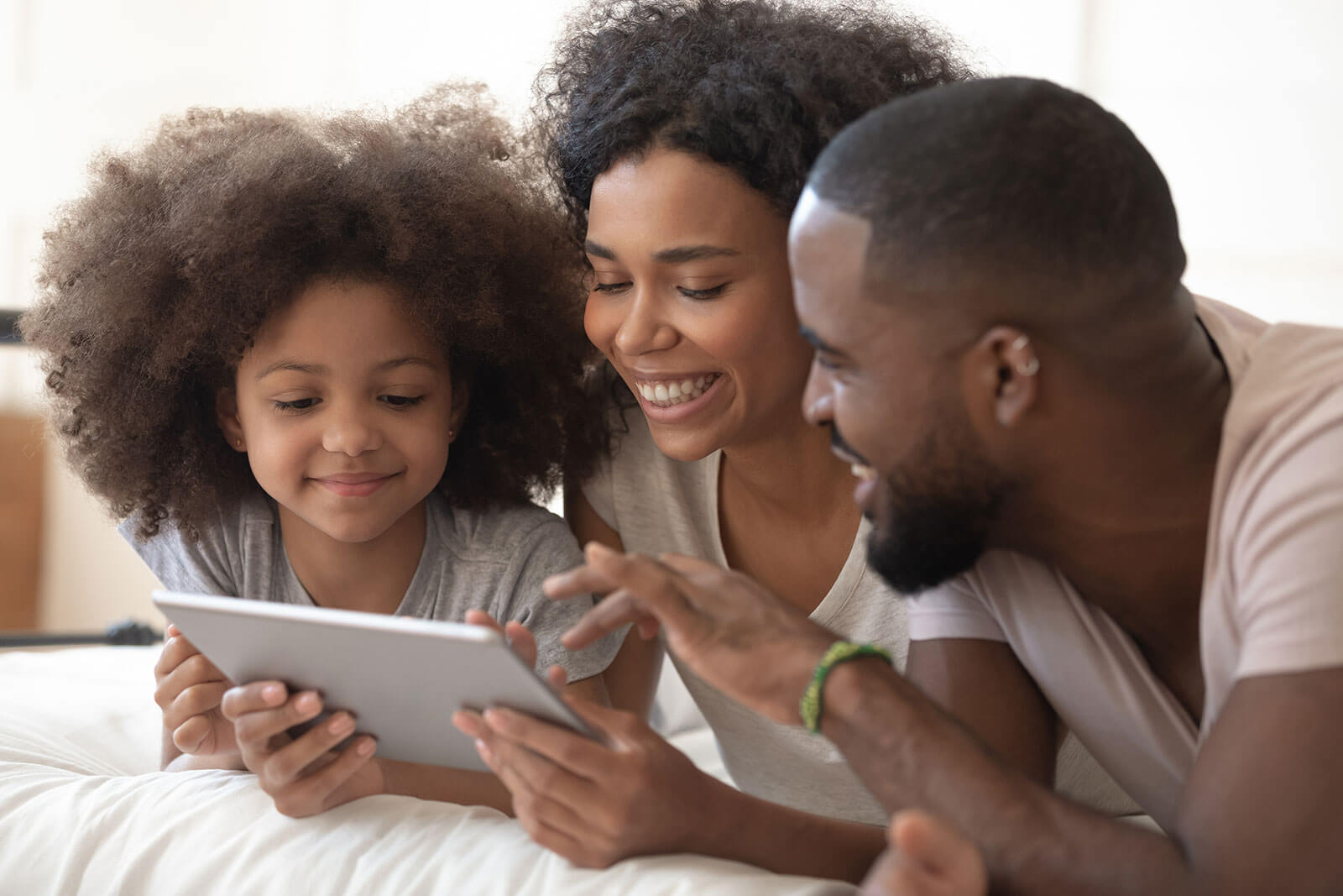 family-laughing-at-elf-yourself-app-on-a-tablet
