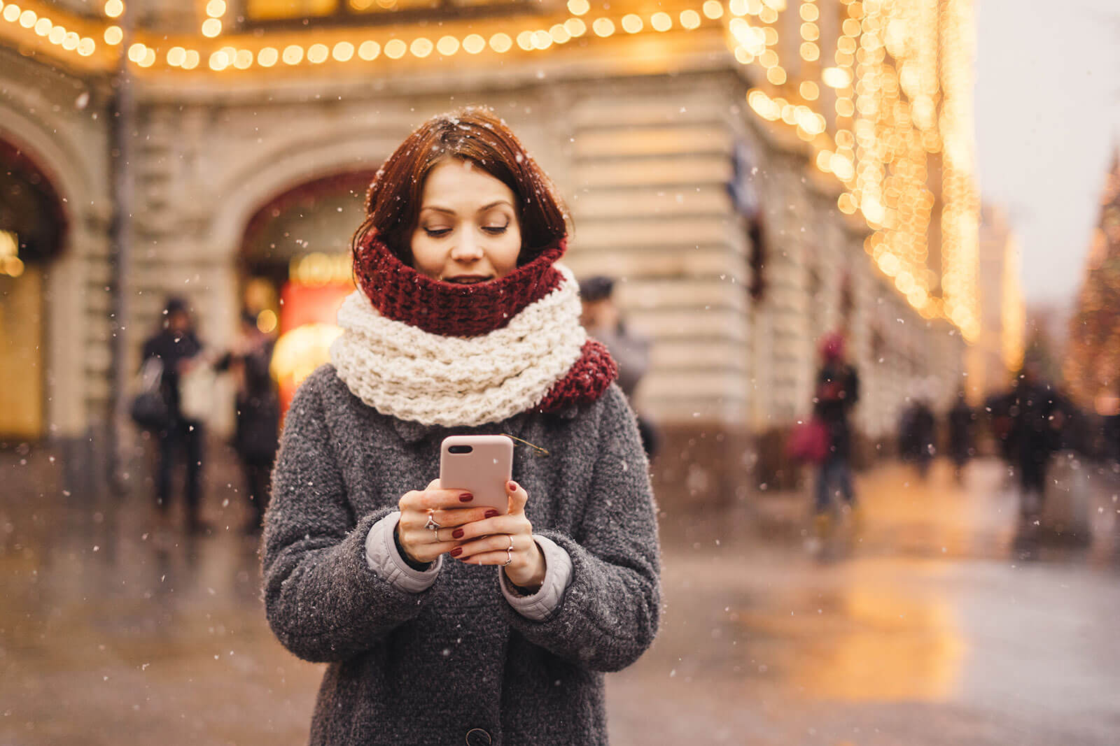 woman-using-an-app-on-her-phone-in-the-snow